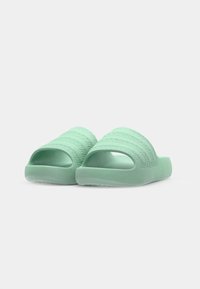 Green slide sandals featuring a textured strap design, made from soft material, with an open toe and heel for easy wear.