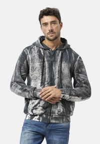 Sweatshirt met capuchon en ritssluiting in een monochroom abstract patroon; met grijze en zwarte tinten, gestructureerde stof en trekkoorden.