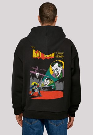 Black hoodie featuring a graphic design with Batman and the Joker in vibrant colors, including yellow, green, and red comic-style illustrations.