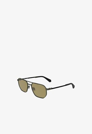 Sonnenbrille mit achtkantigen olivgrünen Rahmen, braunen Gläsern, schlanken schwarzen Bügeln und metallischen Akzenten an der Brücke und den Scharnieren.