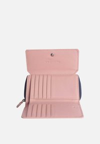Kompakte Geldbörse aus pinkem Leder mit einem navyfarbenen Reißverschluss. Verfügt über mehrere Kartenfächer und einen Druckverschluss mit eingeprägtem Text im Inneren.