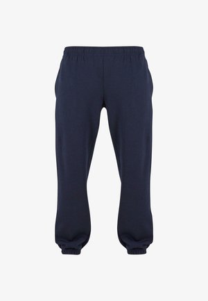 Pantaloni della tuta blu navy con vita elasticizzata e polsini aderenti, realizzati in tessuto morbido, senza motivi o accessori visibili.