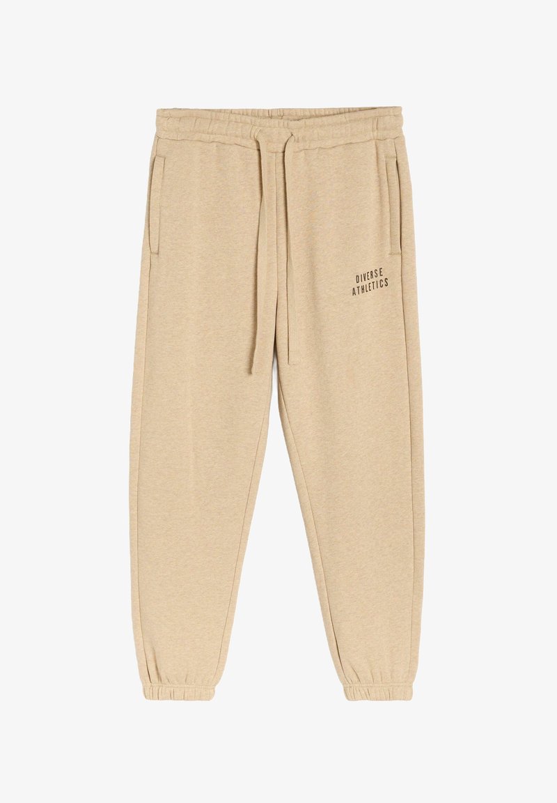 Beżowe dresy wykonane z miękkiego materiału, z elastycznym pasaem, sznurkiem do ściągania, bocznymi kieszeniami oraz nadrukowanym logo "Diverse Athletics".