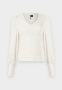 Hvit strikket topp med V-hals, lange puff-ermer og diamants mønster. Ribbet mansjetter på ermeenden. Mykt, lett materiale.