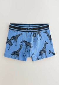 Blå boxer shorts med giraffmønster i sort. Blødt bomuldsstof med en sort elastikbånd, der viser "NEXT" i kontrastfarve.
