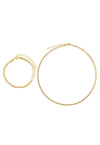 Set di gioielli in tonalità oro composto da una sottile collana rotonda testurizzata e un braccialetto. Ogni pezzo ha una catena delicata e una chiusura per una vestibilità sicura.