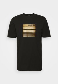 Black cotton t-shirt featuring a gold-striped graphic with the word “MORATO” at the top. Round neckline and short sleeves.