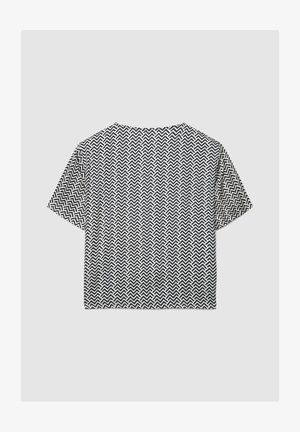 T-shirt a maniche corte corta con motivo a zigzag bianco e nero. Realizzata in tessuto leggero, con vestibilità comoda e scollo rotondo.