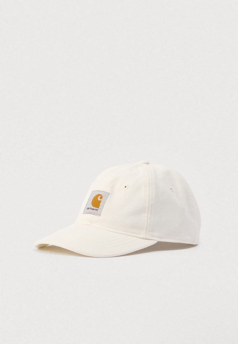 Cappellino da baseball Carhartt color avorio con visiera curva e patch rettangolare con logo giallo e grigio sul pannello frontale.