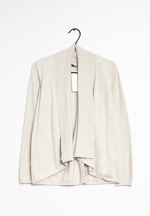 Beige cardigan av mjukt stickat tyg, med öppen front, långa ärmar och en längre bakre nederkant. Diskret ribbad textur.