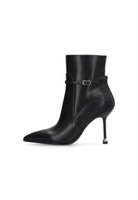 Black ankle boot made of smooth leather with a pointed toe, thin stiletto heel, and a decorative strap with a metallic buckle detail.