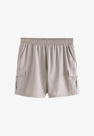Svetlo béžové šortky s elastickým pásom a dvoma kapsami s klopami na každej strane, vyrobené z hladkej látky.