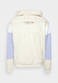 Felpa con cappuccio color beige chiaro con tasca a marsupio, maniche bianche e lavanda, cappuccio con coulisse regolabile e logo stampato sul davanti.