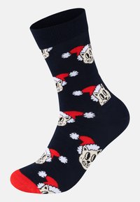 Ναυτικά καλσόν με επαναλαμβανόμενο σχέδιο κρανίων που φορούν κόκκινα χριστουγεννιάτικα καπέλα, με σόλα σε έντονο κόκκινο χρώμα και ριγέ μανσέτα για επιπλέον υφή.