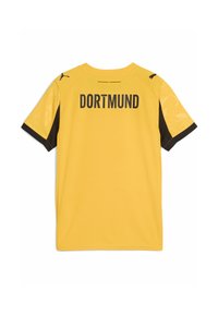 Rumena in črna nogometna majica Borussia Dortmund, kratki rokavi, "DORTMUND" natisnjeno v debelem črnem na hrbtu, logotipi Puma na ramenih.