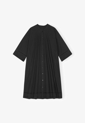 Juoda laisvo silueto suknelė su priekinėmis sagomis, trijų ketvirčių rankovėmis, apvalia iškirpte ir dekoratyvinėmis siūlėmis ant rankovių bei suknelės krašto.