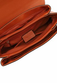 Orange crossbody bag with a textured exterior, featuring multiple compartments, a zippered pocket, and smooth interior lining.