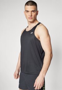 Black sleeveless athletic tank top made of a lightweight, textured fabric. Features a rounded neckline and a small logo on the chest.