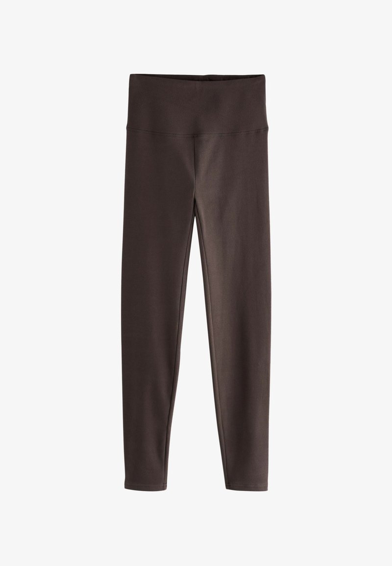 Leggings marron en tissu doux et extensible. Dotés d'une ceinture large et d'un design ajusté qui se rétrécit aux chevilles.