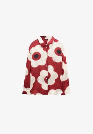 Koszula na guziki z długim rękawem, ozdobiona dużymi białymi i czerwonymi wzorami kwiatów z czarnymi środkami na czerwonym tle.