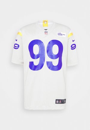 Maillot blanc des Los Angeles Rams NFL avec le numéro violet 99, des accents jaunes aux épaules et le logo de l'équipe en haut à droite de la poitrine.