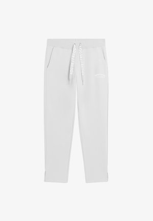 Pantaloni della tuta grigio chiaro con tasche laterali, vita elastica e coulisse marchiate con la scritta "FREDDY" su sfondo bianco.