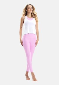 White sleeveless top with a rounded neckline, paired with form-fitting pink leggings. Smooth texture, fitted design, and minimalist style.
