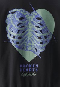 Black sweatshirt featuring a graphic design of ribcage and heart in blue and green, with "BROKEN HEARTS" text at the bottom.