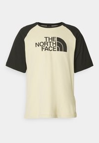 Kortærmet t-shirt med cremefarvet krop og sorte raglanærmer. Har "THE NORTH FACE" logoet i sort på tværs af brystet. Materiale i bomuld.