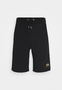 Black sweat shorts made of cotton, featuring a drawstring waist and gold logo detail on the hem. Smooth texture, knee-length design.
