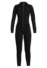 Black denim jumpsuit with long sleeves, front zipper, two chest pockets, fitted design, and tapered legs for a streamlined silhouette.