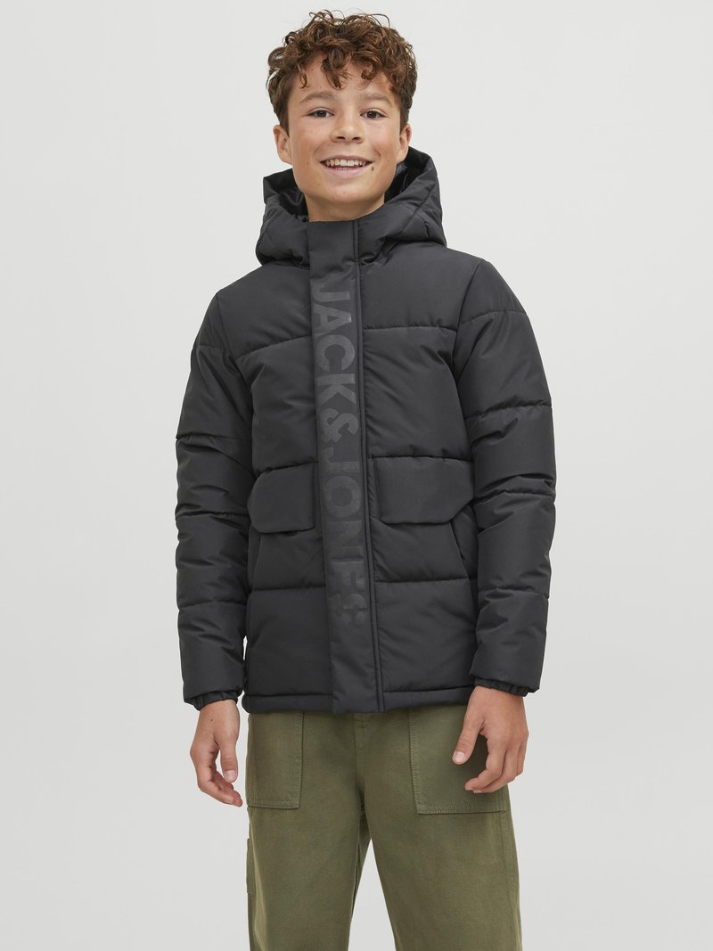 Black puffer jacket with a hood, featuring a vertical logo stripe, two front pockets, and elastic cuffs. Worn with olive green pants.