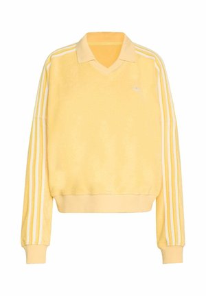 Żółta polarowa bluza z dekoltem w serek, białymi trzema paskami na rękawach oraz małym logo na piersi.