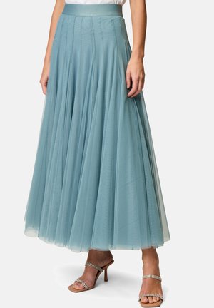 A flowing, light blue tulle skirt with a fitted waistband, featuring vertical pleats and a long, layered design, paired with strappy heels.