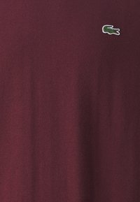 Lacoste Stickad tröja - bordeaux