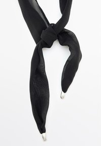 Foulard nero in seta, leggero con una texture trasparente, annodato al centro, con estremità in metallo argentato.