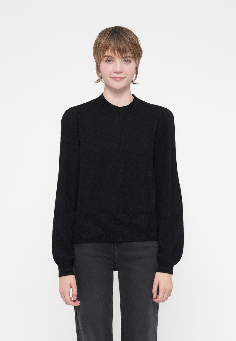 Black knit sweater with a round neck, long balloon sleeves, fitted cuffs, and a ribbed waistband. Minimalist design with no visible patterns.