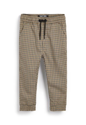 Pantalon à carreaux marron, noir et blanc avec taille élastique et cordon de serrage noir, chevilles resserrées et poches latérales.
