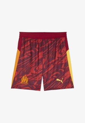 Piros és sárga mintás focinadrág rugalmas derékkal, alul jobbra elhelyezett logóval és sárga Puma emblémával.