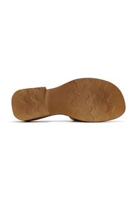 Brown rubber outsole with a wavy tread pattern, flat heel, smooth texture, and a wide toe area designed for comfort and traction.