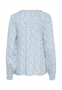 Himmelbluse mit floralen Muster, die kleine gelbe und blaue Blumen zeigt, mit gerafftem Ausschnitt und langen Ärmeln mit elastischen Bündchen. Weicher Stoff.