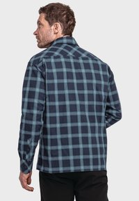 Hemd mit kariertem Muster in Marineblau und Hellblau, mit geknöpften Manschetten und Kentkragen, das eine glatte Textur und einen lässigen Schnitt aufweist.