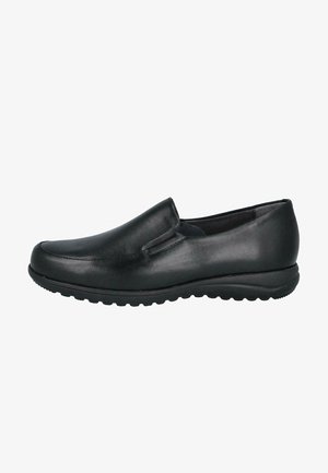 Zapato negro de piel deslizante con puntera redondeada, textura suave y costuras mínimas. Presenta una suela de goma con detalles de agarre.