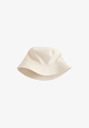 Sombrero tipo bucket beige de algodón con detalles cosidos y ala inclinada hacia abajo, mostrado sobre un fondo blanco.