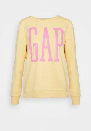 Yellow long-sleeve sweatshirt with large pink "GAP" letters centered on the front.