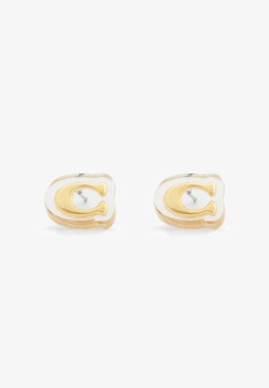 Pair of gold-tone letter C stud earrings with clear resin backing and silver posts on white background.