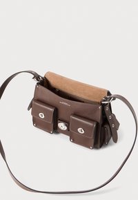 Brown leather handbag with two front pockets, silver hardware, a zippered inner compartment, and a long adjustable shoulder strap.