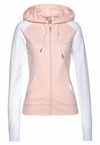 Helle rosa Kapuzenjacke mit weißen Ärmeln, Kordelzugkapuze und Fronttaschen. Merkmale sind ein dezentes Logo an der Seite und gerippte Bündchen.