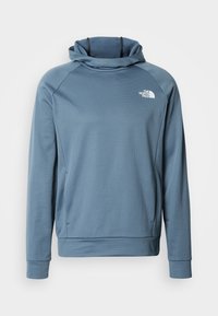 Ανοιχτό μπλε φούτερ με κουκούλα τύπου κασκόλ, μανίκια ράγκλαν, υφασμάτινη υφή και το λογότυπο The North Face σε λευκό στην αριστερή πλευρά του στήθους.