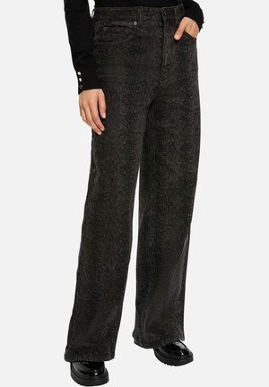 Jeans larges noirs avec une texture subtile imprimée serpent, fabriqués en denim à la finition lisse. Dotés d'un style classique à cinq poches et de passants de ceinture.